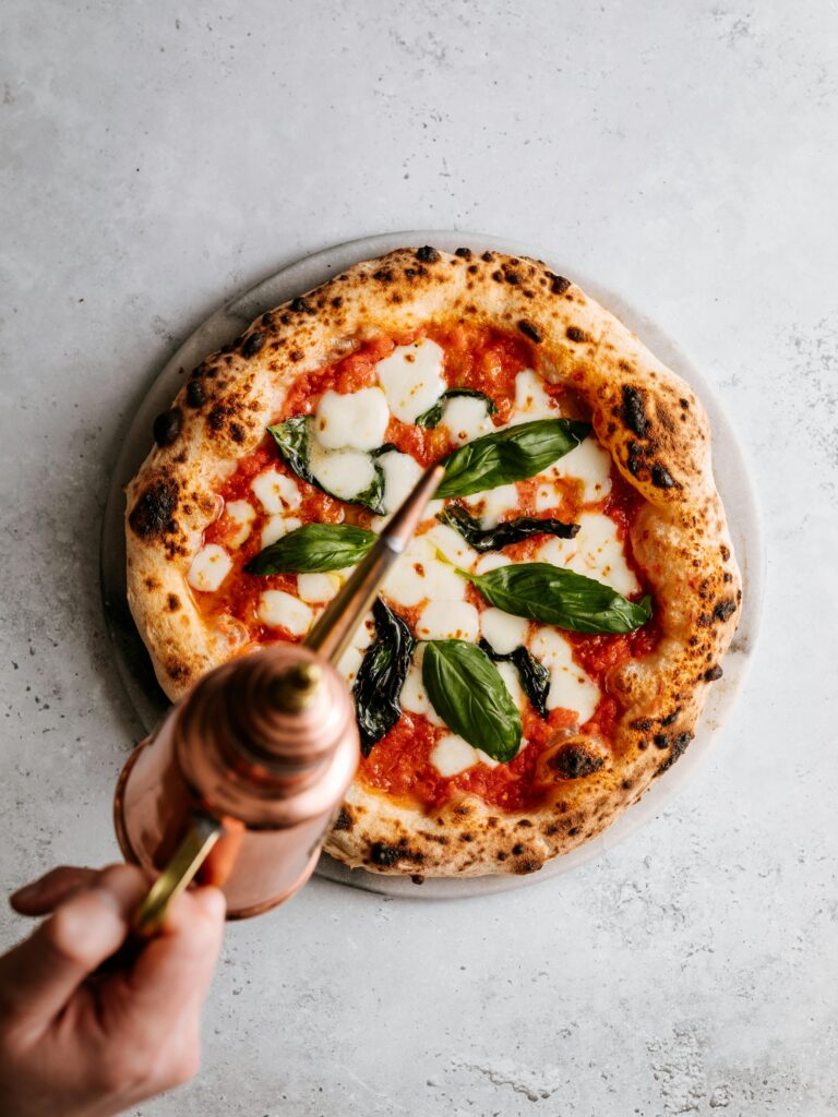 Delicious Italian pizza topped with mozzarella, basil, and olive oil. A classic culinary delight.