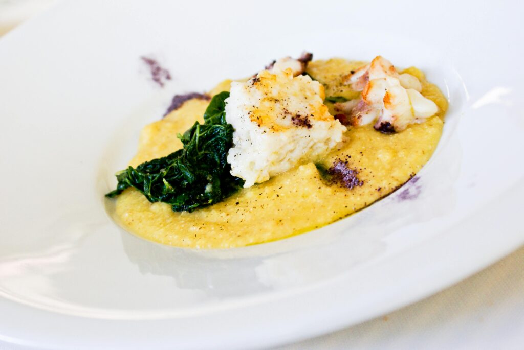 Delicious lobster with creamy polenta and spinach, an Italian cuisine delicacy.