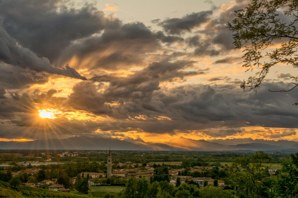 Dramatic sunset over Buttrio, Italy, highlighting the picturesque landscape and radiant skies.